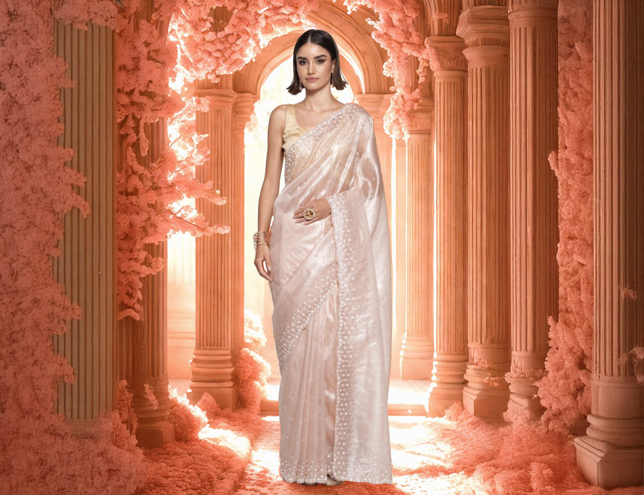 A woman in a beautiful pink organza saree